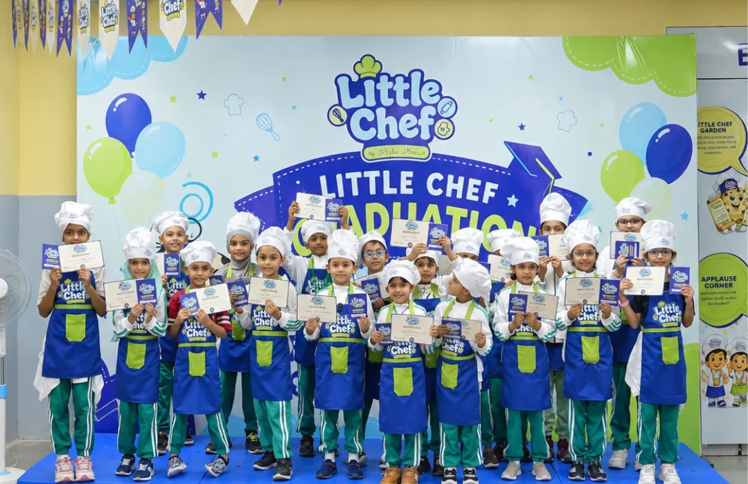 A class of Little Chefs holding their certificates at graduation