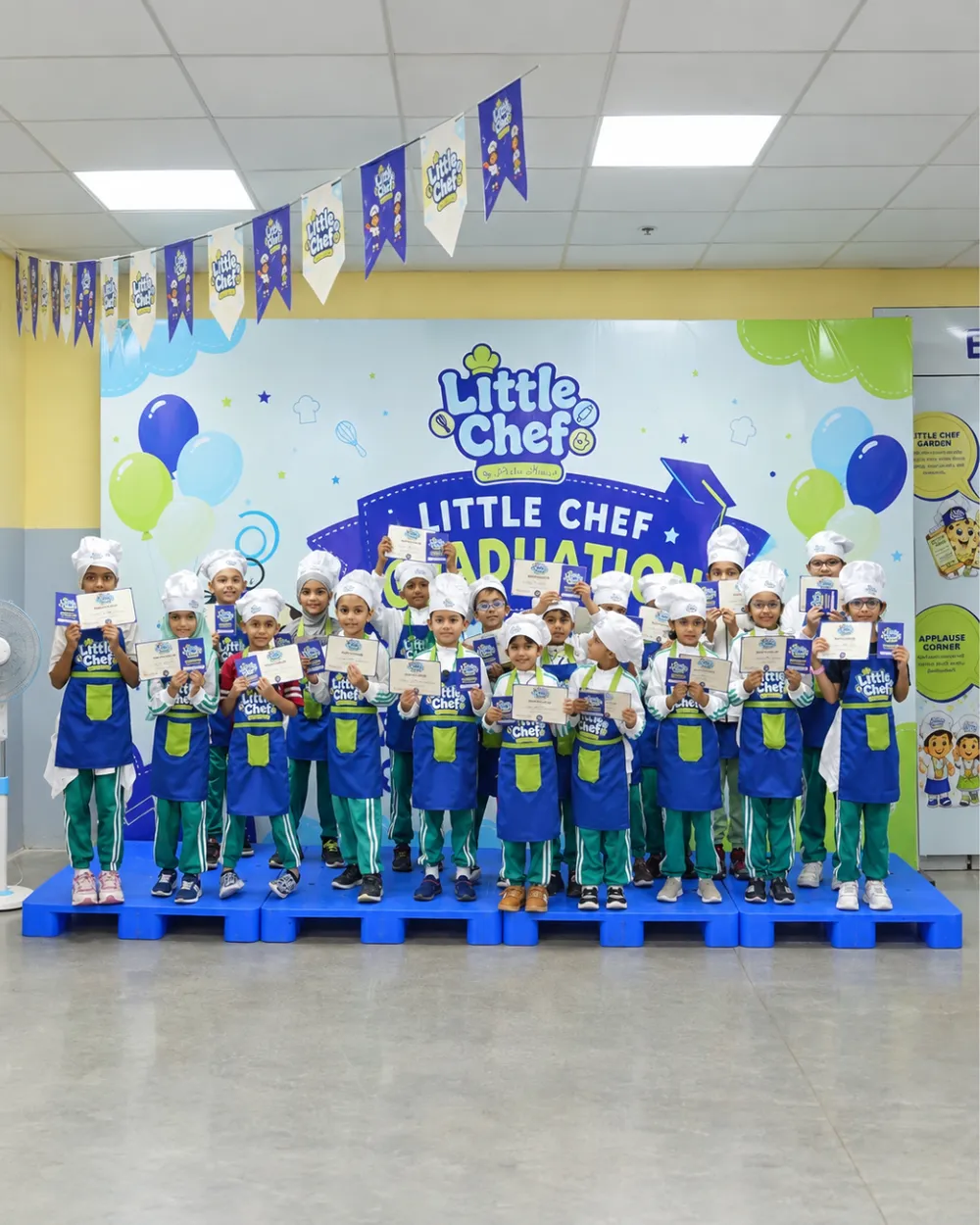 Little Chefs holding their graduation certificates